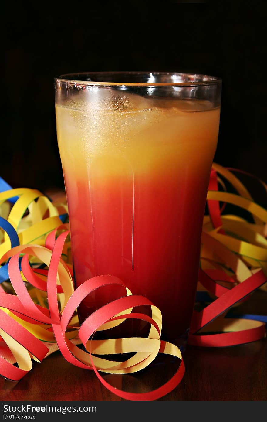 Cocktail (Tequila Sunrise) with blow-outs on a table