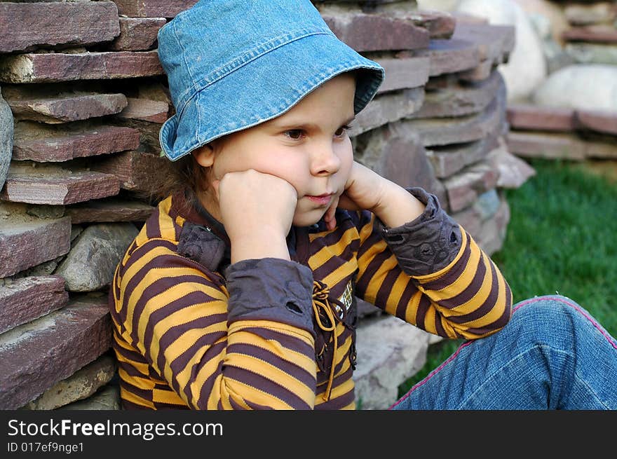 Little girl sitting and thinking about problems