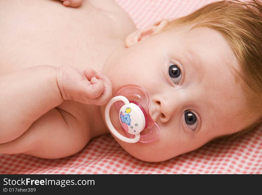 Little baby girl on pink cover