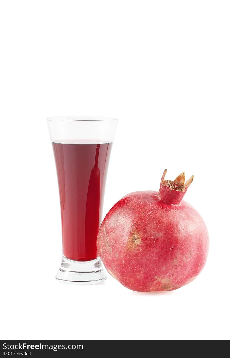 Glass of garnet juice and pomegranate fruit.