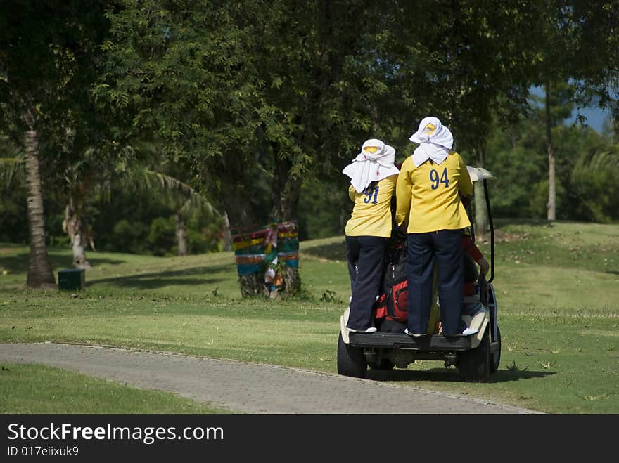 Two caddies on a golf cart