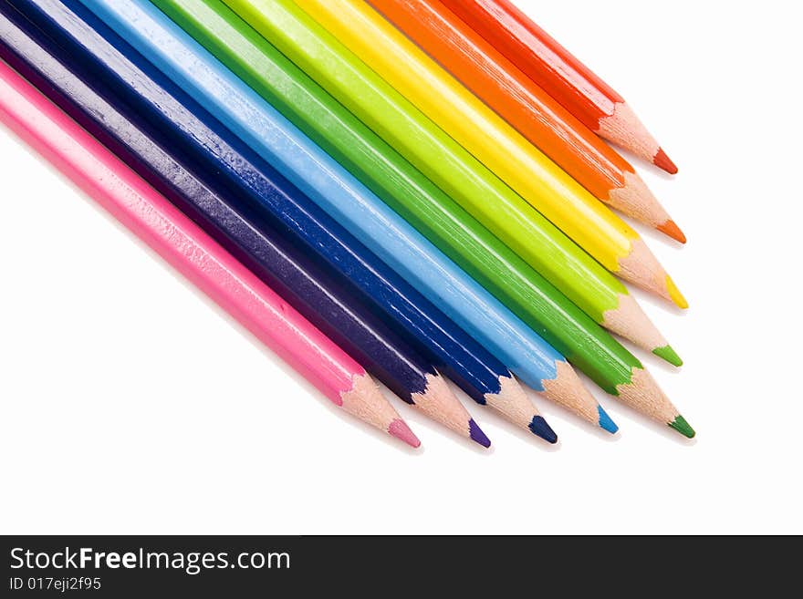 Colored pencils on white background. Colored pencils on white background