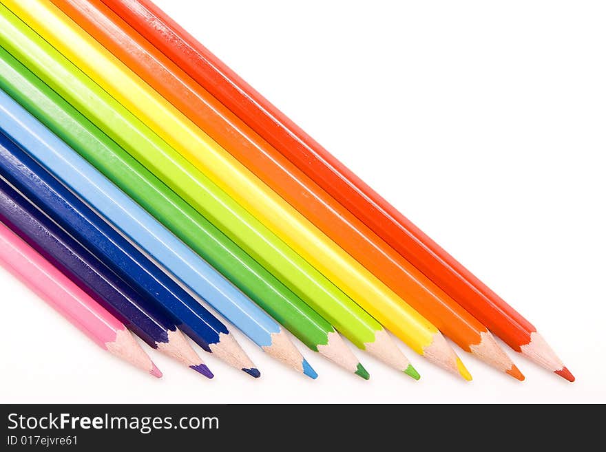 Colored pencils on white background. Colored pencils on white background