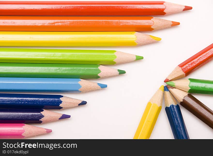 Colored pencils on white background. Colored pencils on white background