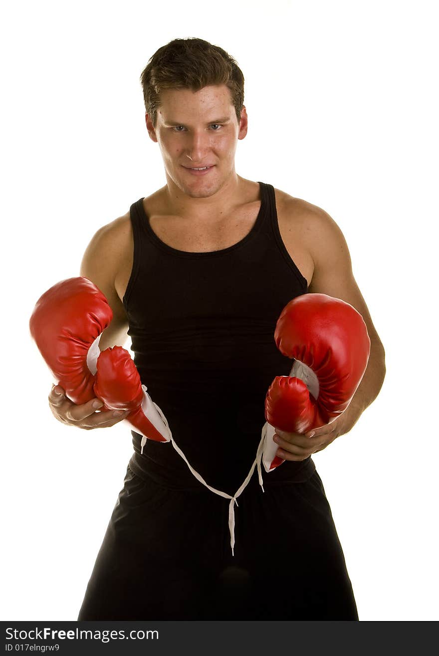 A boxer in workout clothes and red boxing gloves isolated on white. A boxer in workout clothes and red boxing gloves isolated on white