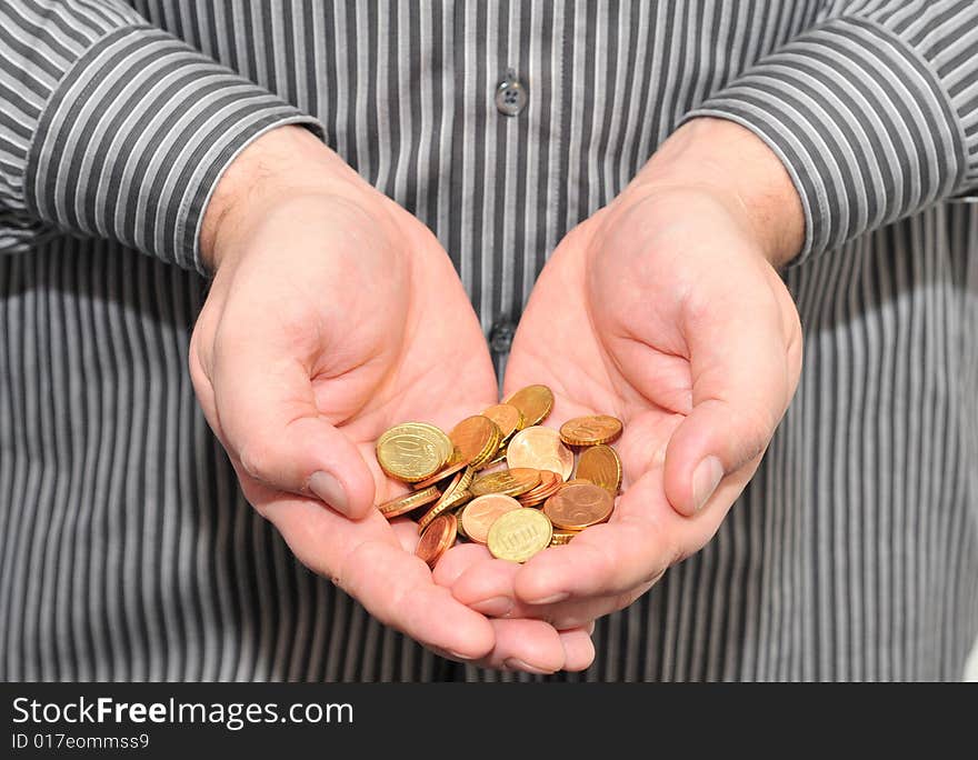 Man's hands with coins