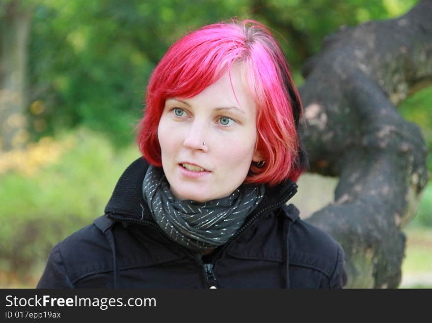 Portrait of a young woman with coloured red hair