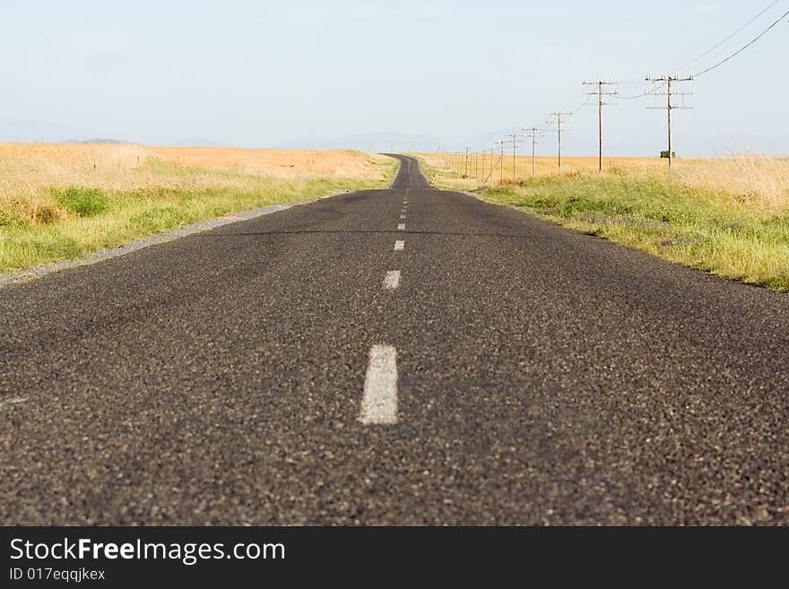 Endless tarred country road in rural South Africa disappearing into the horizon. Endless tarred country road in rural South Africa disappearing into the horizon