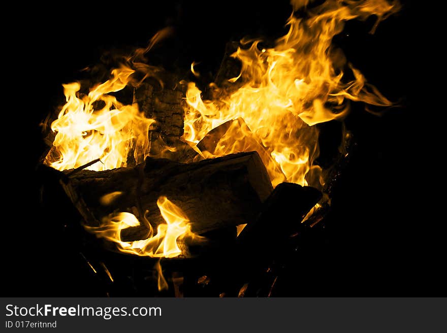 Fire flames raising in a dark background