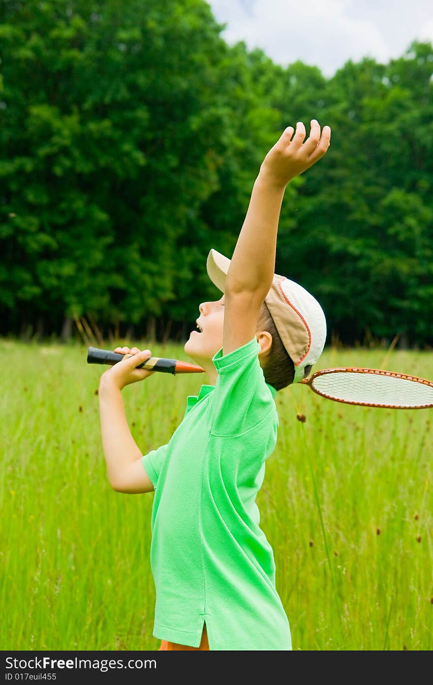 Cute kid playing badminton outdoors