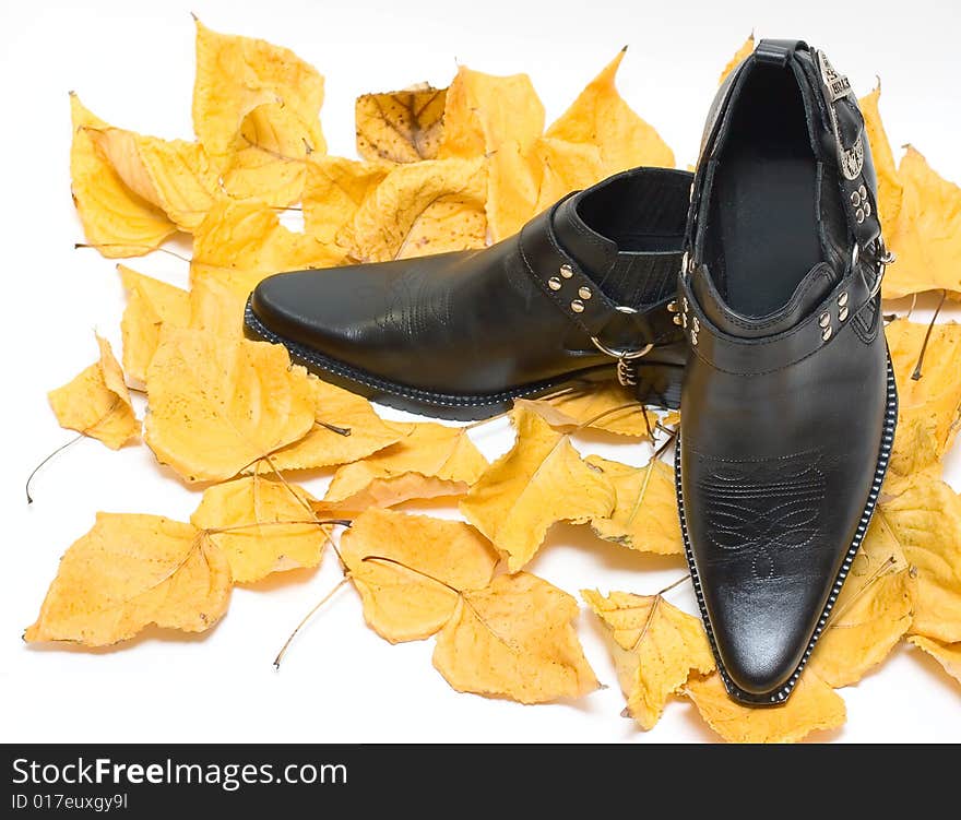 Man shoes on Fall leafs isolated on white