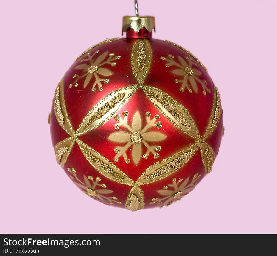 Red and gold Christmas ornaments against pink background. Red and gold Christmas ornaments against pink background