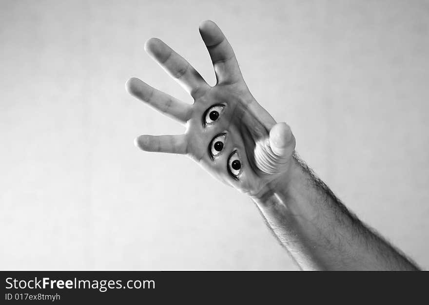 The hand in desperate gesture with three eyes. The hand in desperate gesture with three eyes