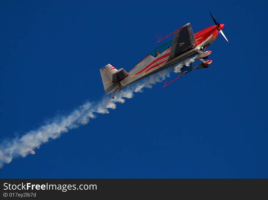 Red and white airplane in the sky