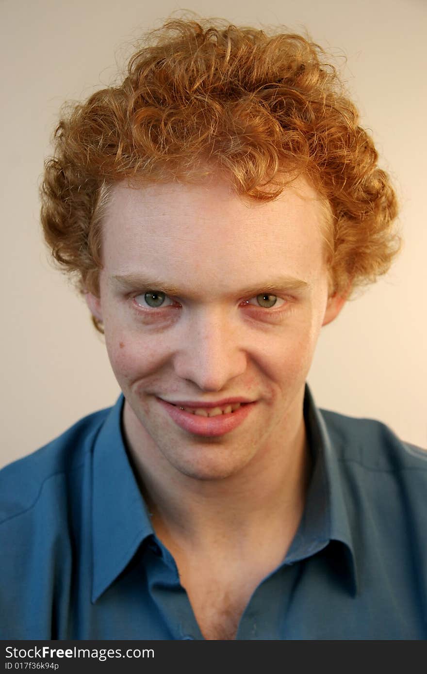 A young red-haired man with an evil grin on his face. A young red-haired man with an evil grin on his face.