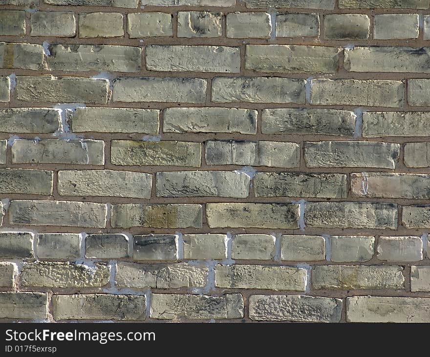 Weathered brick wall with neutral colored bricks