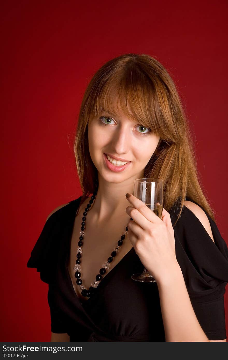 Sensual girl with champagne glass on dark red background