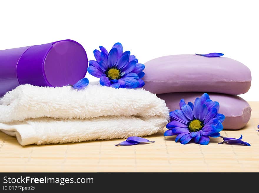 Spa essentials, soap and towel with blue flowers