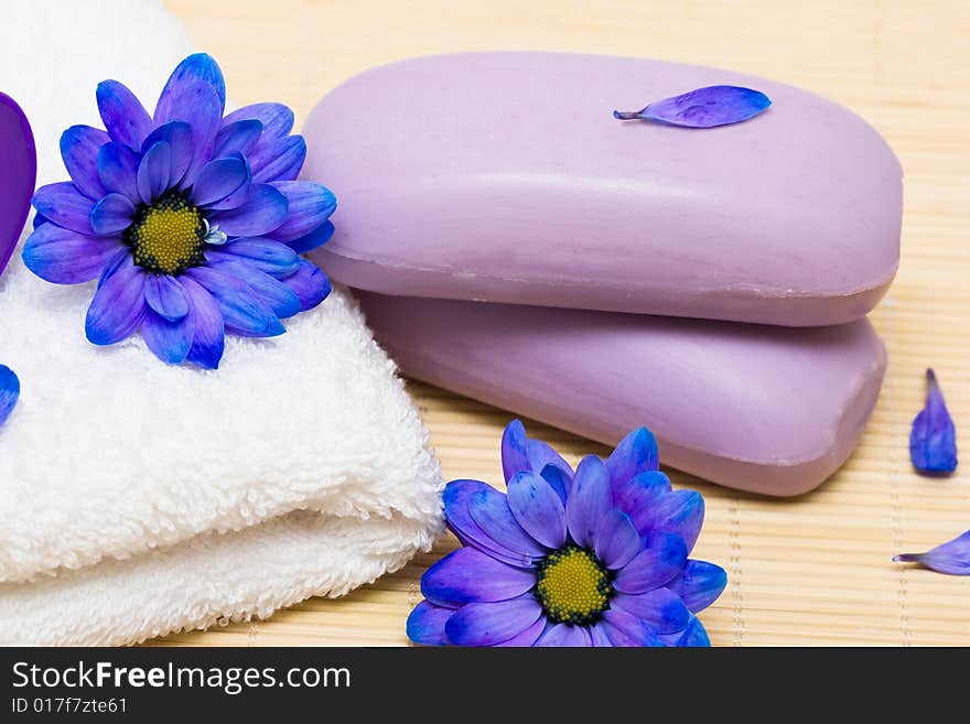 Spa essentials, soap and towel with blue flowers