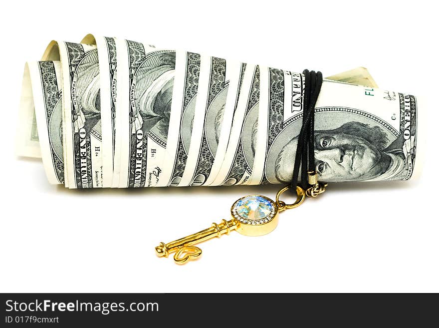 Golden key and dollars isolated on white