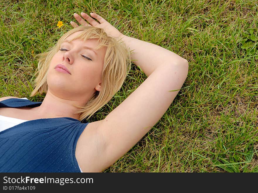 Close portrait of attractive blond girl in garden. Close portrait of attractive blond girl in garden