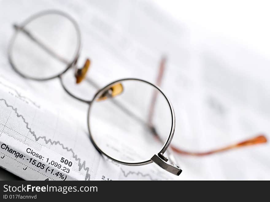 Glasses on a newspaper stock report. Glasses on a newspaper stock report