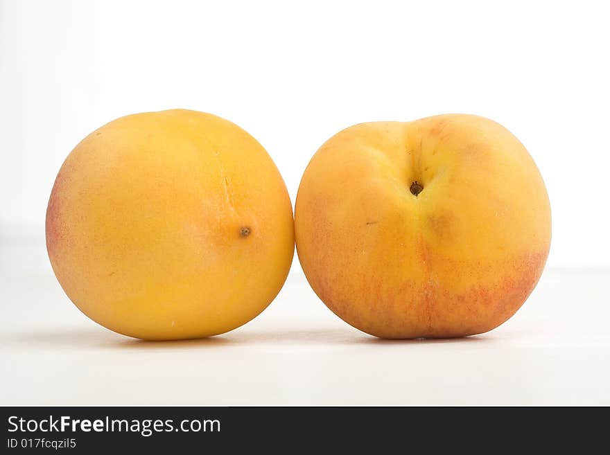 Fresh peaches isolated on a white background