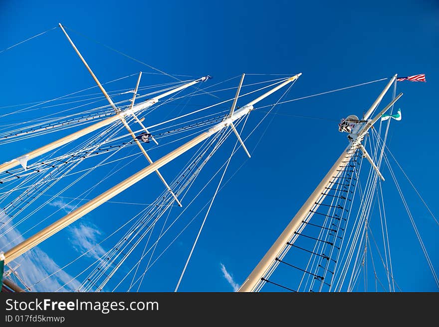 Ship masts against the blue sky