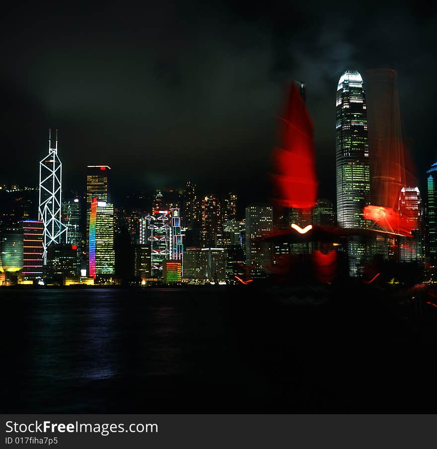 A red sail in the Victoria Bay, Hong Kong