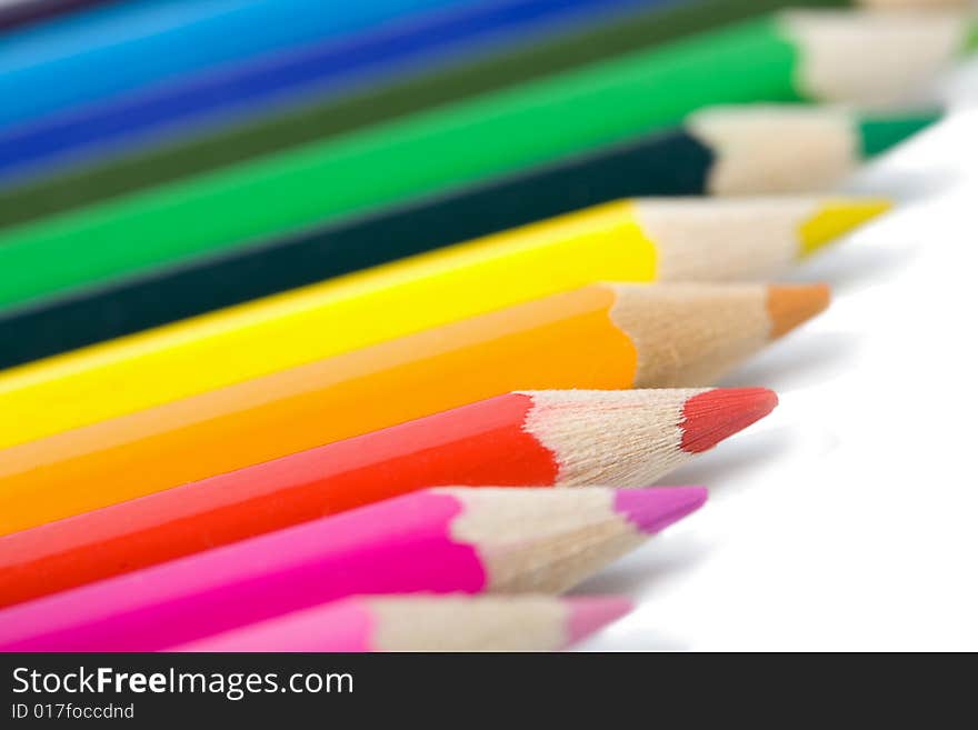 Line of colorful pencils isolated on white