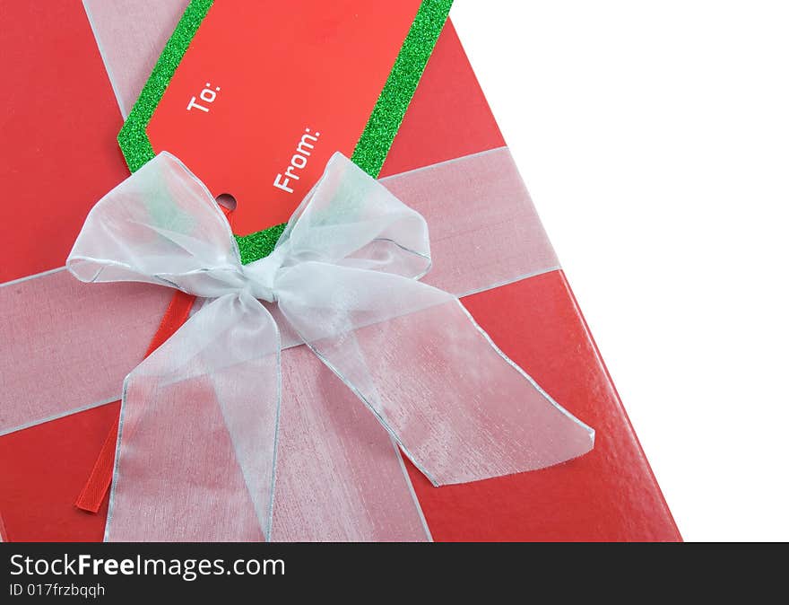 Gift wrapped present with bow and tag isolated on white