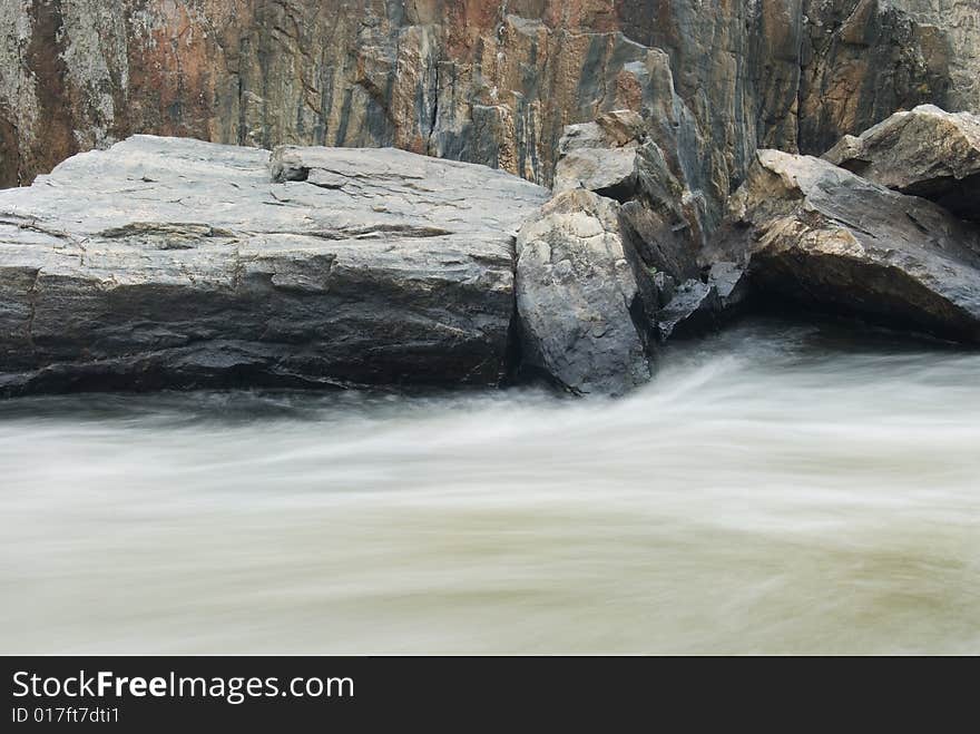 Long exposure motion blurred river and granite stone. Long exposure motion blurred river and granite stone