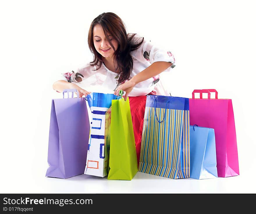 Shopping girl look over shopping bags,isolated on white background. Shopping girl look over shopping bags,isolated on white background