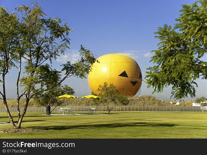 Orange Hot Air Balloon Resting on Ground