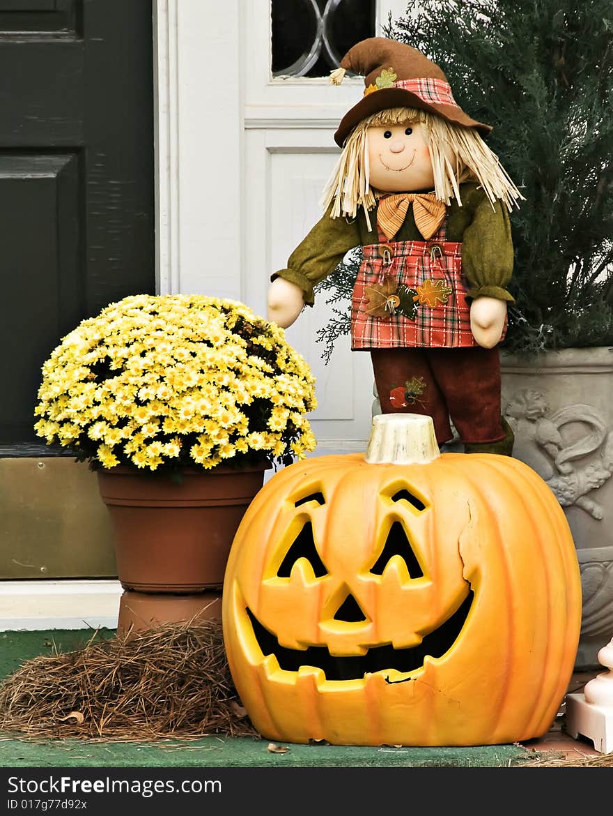 Smiling scarecrow and pumpkin