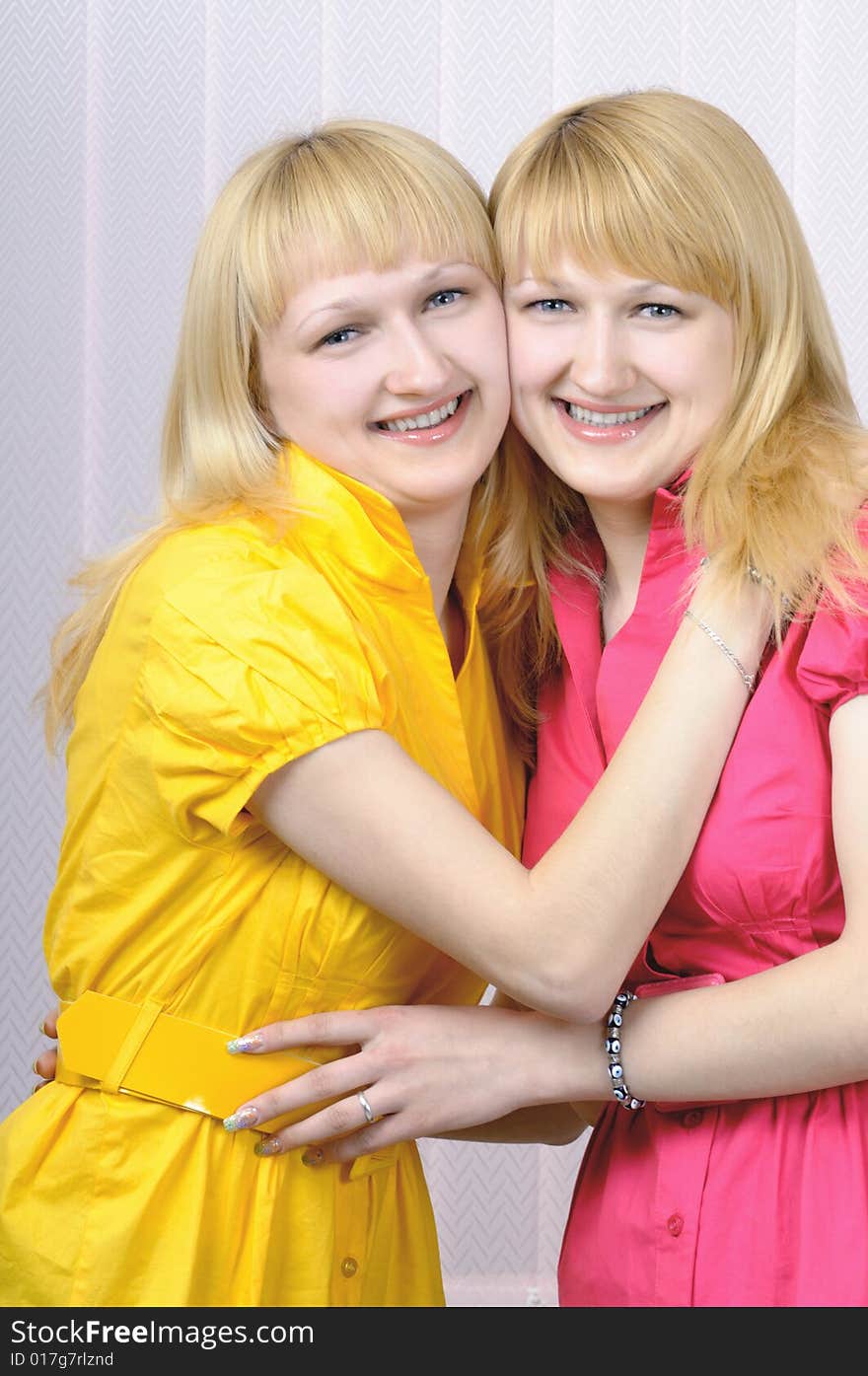 Two attractive blond smiling sisters. Two attractive blond smiling sisters