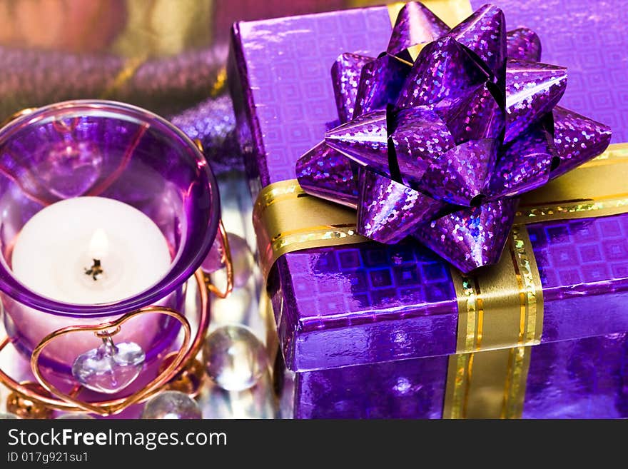 Violet candle with heart and gift box