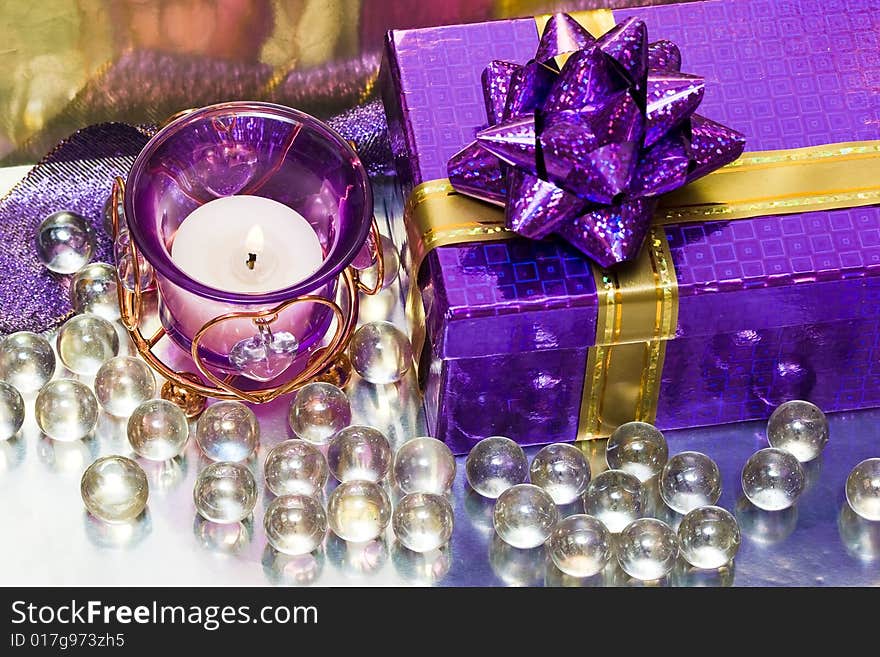 Violet candle with heart and gift box