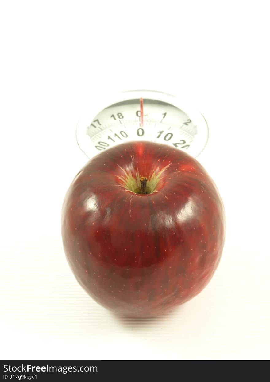 Apple on scales on isolated background. Apple on scales on isolated background.