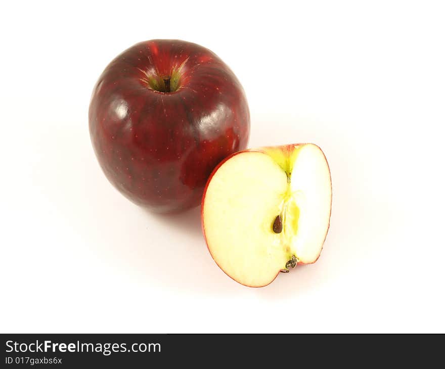 Red apple with one cut to show the seed inside; on isolated background. Red apple with one cut to show the seed inside; on isolated background.