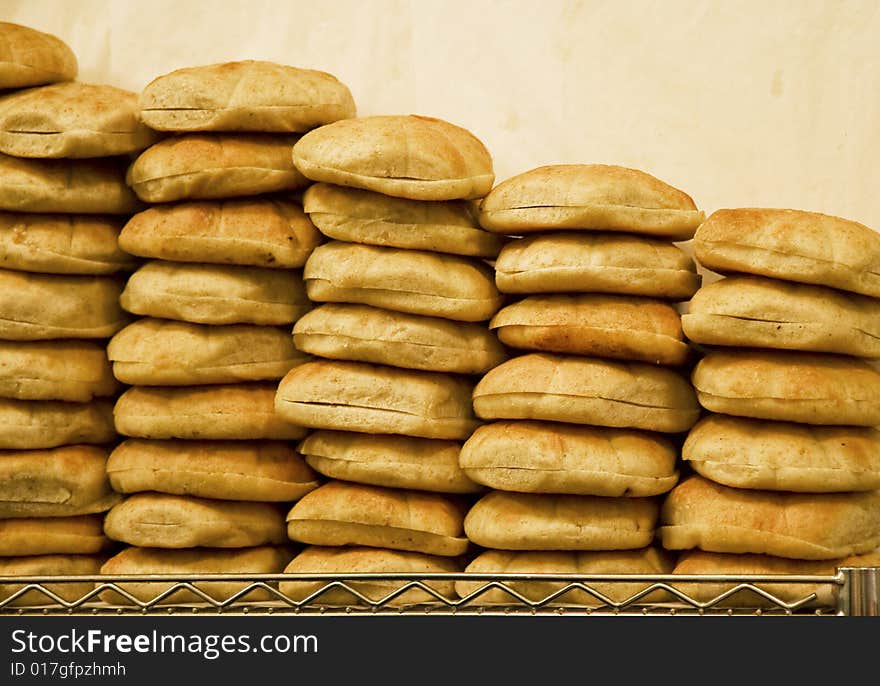 Stacks of fresh baked bread at a bakery. Stacks of fresh baked bread at a bakery