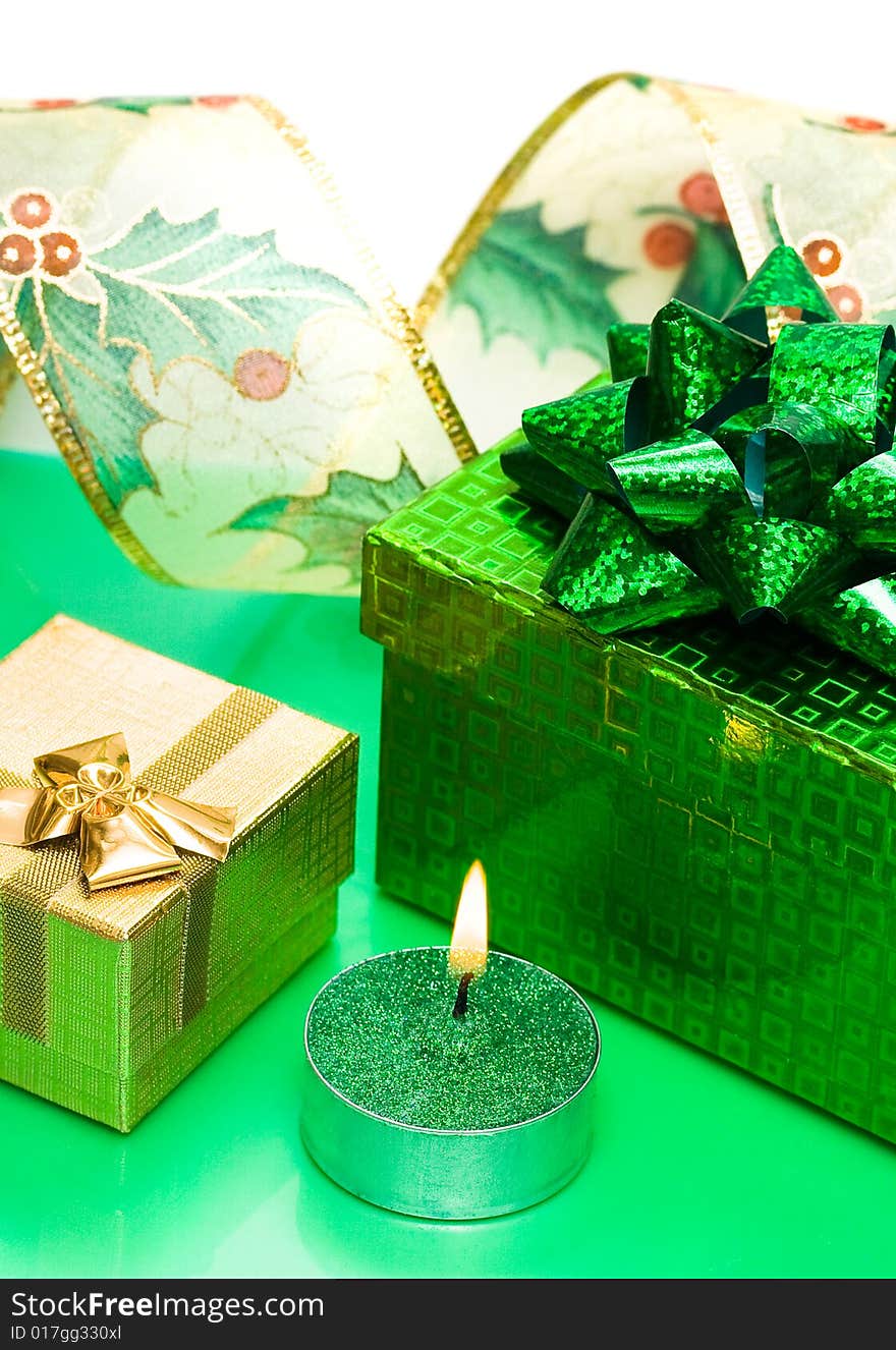 Golden gift box and burning candle. Golden gift box and burning candle