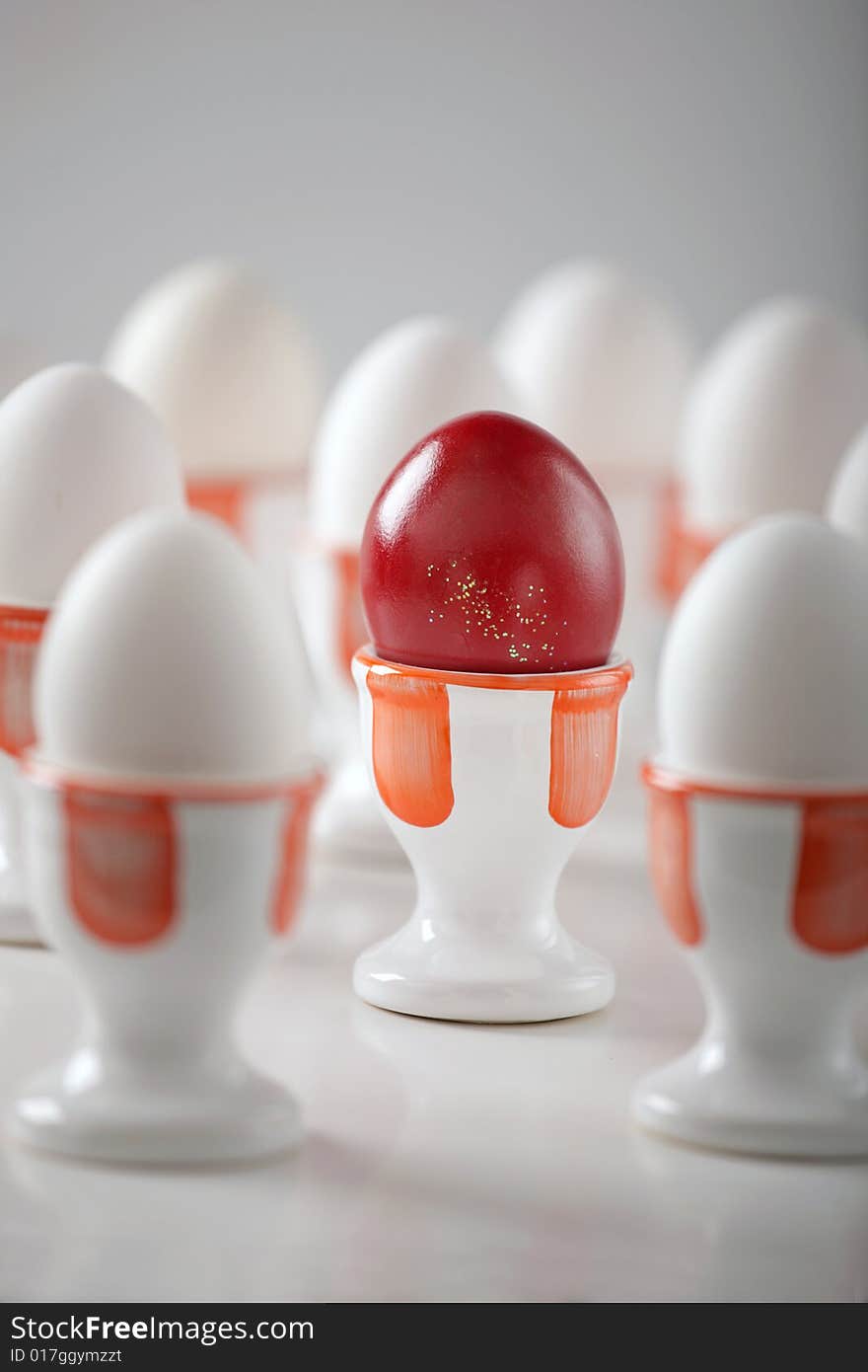 Red egg with dozen white eggs