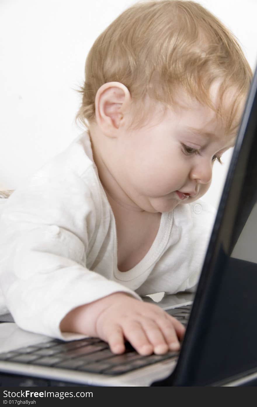 Curious baby playing with laptop