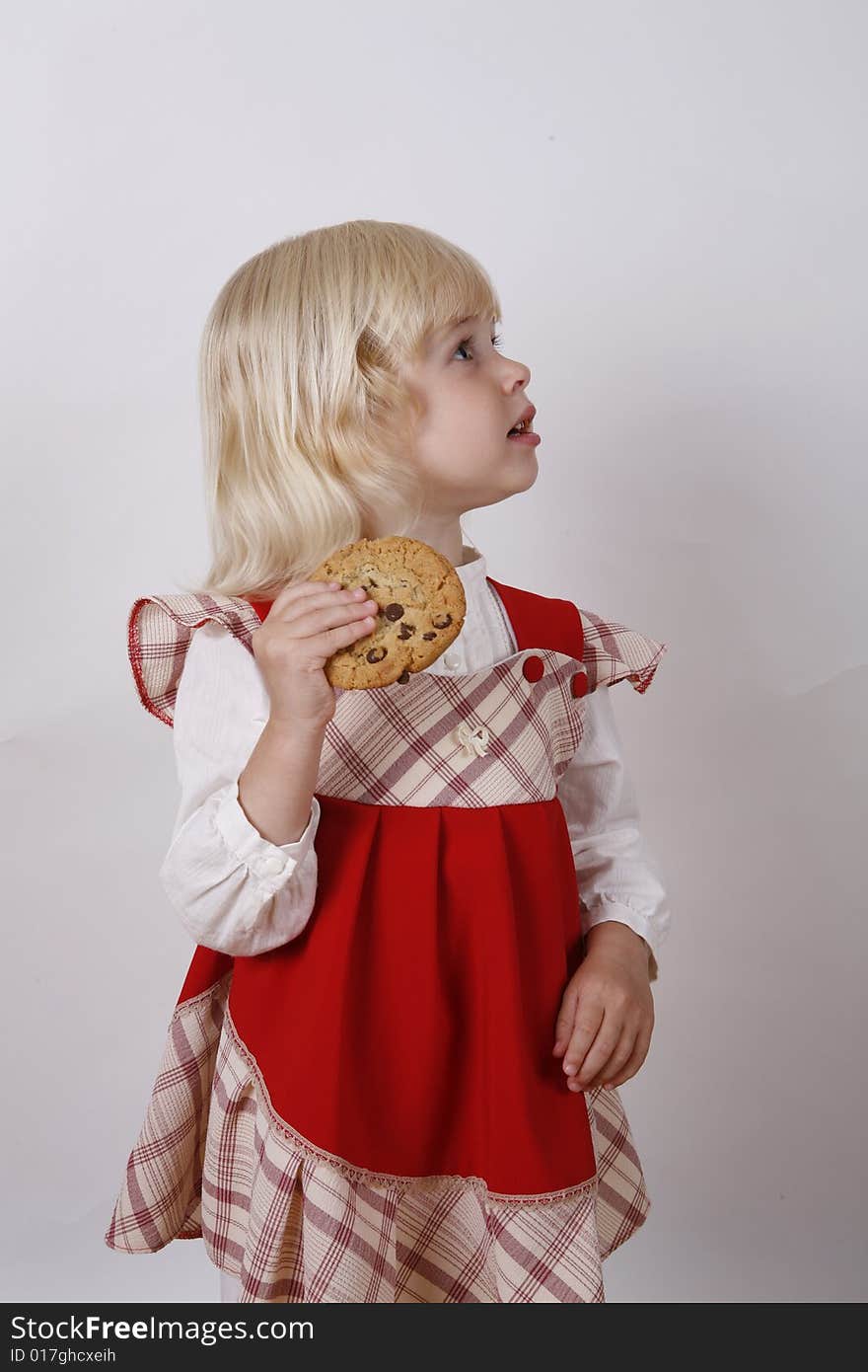 Sweet girl eating chocolate chip cookie. Sweet girl eating chocolate chip cookie