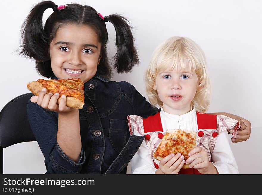 Sweet girls eating cheese pizza slice. Sweet girls eating cheese pizza slice