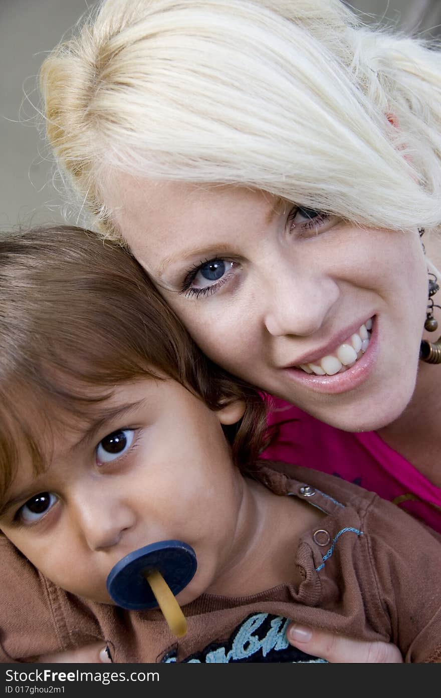 Boy with pacifier posing with his mother. Boy with pacifier posing with his mother