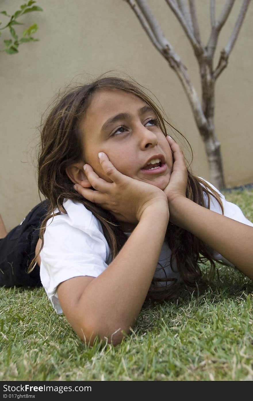 Adorable Boy Lying On Grass And Looking Aside