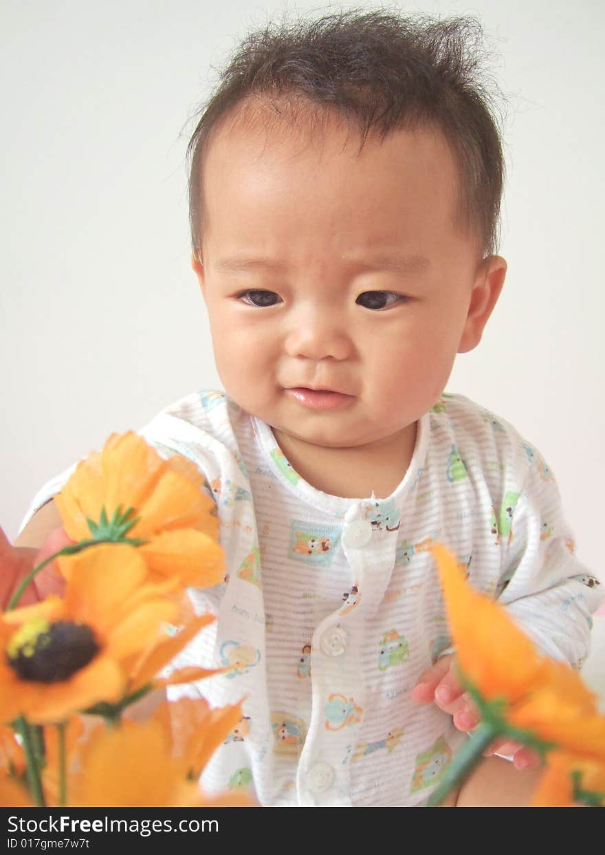 A cute baby and flower. A cute baby and flower