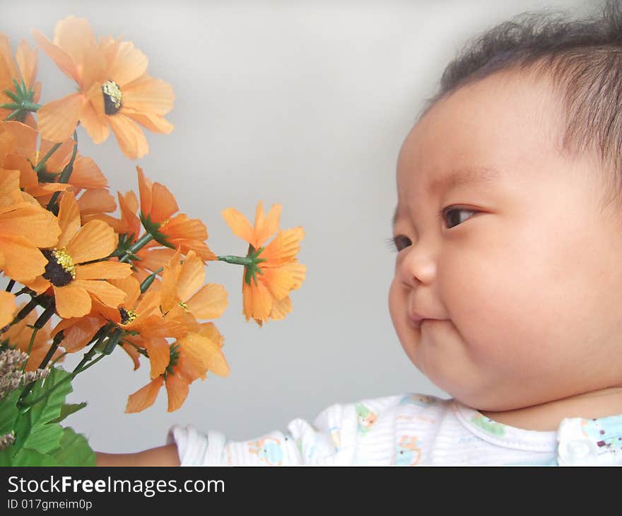 A cute baby and flower. A cute baby and flower